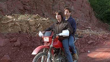 Dakota House in a television scene on a motorcycle